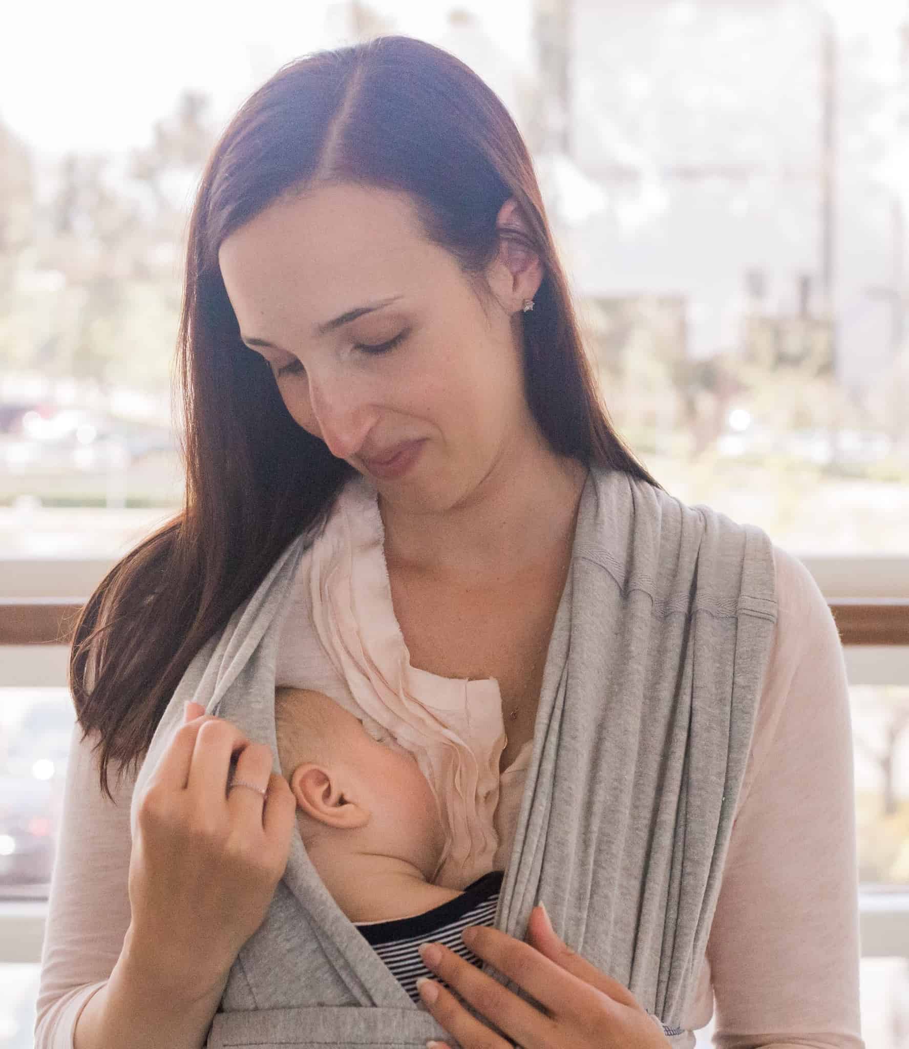 New mom with baby in baby carrier.